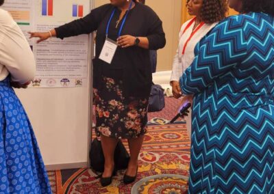 Someone presenting a poster at an academic conference