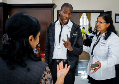 A group of three people having a conversation.