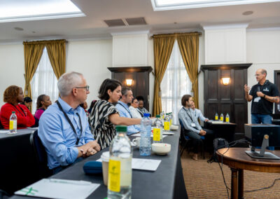 A man presents to a room full of people.